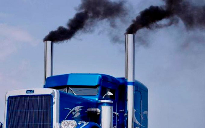 Blue truck expelling exhaust gases